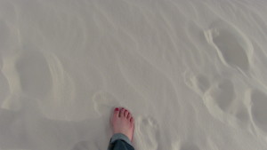 The author's feet in the white sand.  Photo copyright Sara J. Bruegel, 2016