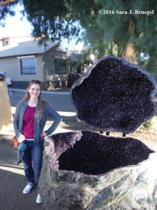 The author with a large, egg-shaped geode.  Photo copyright Sara J. Bruegel, 2016