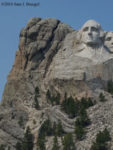 Notice the bent and cracked rocks by the presidents' faces at Rushmore. Notice the little white streak on the right side of Washington's forehead